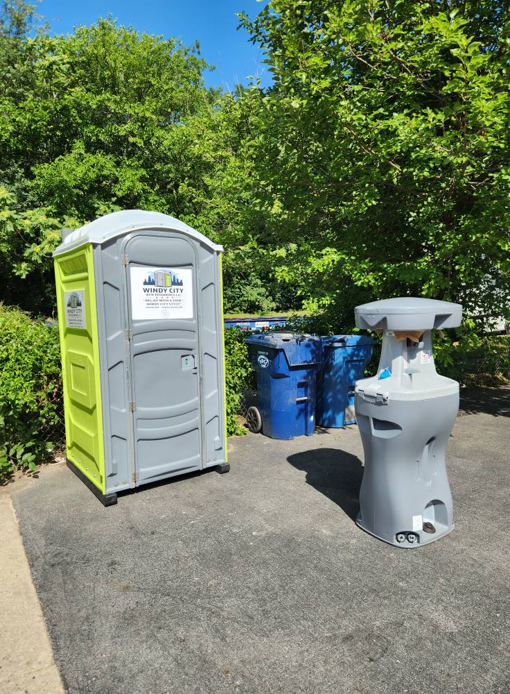 Windy City porta potty with a hand-wash sink station set up at an event