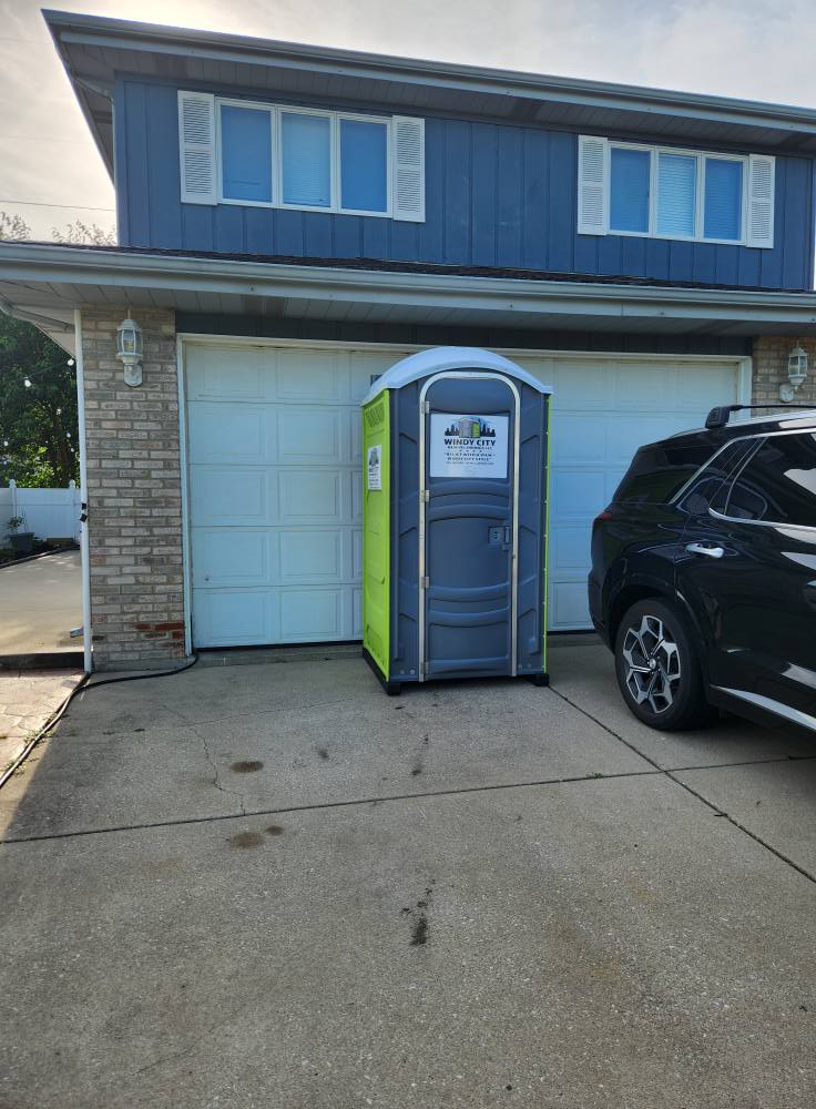 Windy City porta potty delivered to a residential driveway for a party