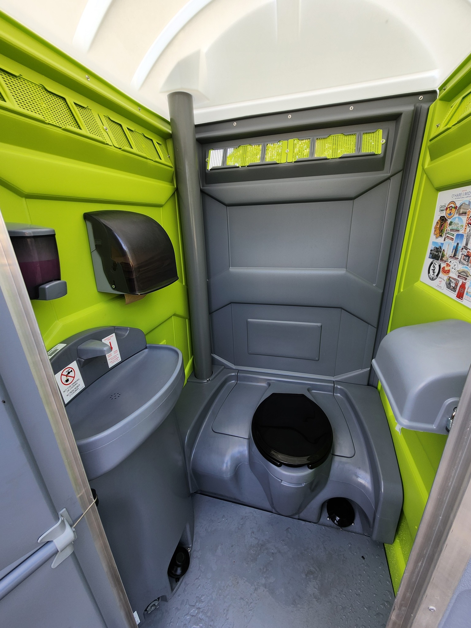Clean interior of a Windy City deluxe flushable porta potty with sink